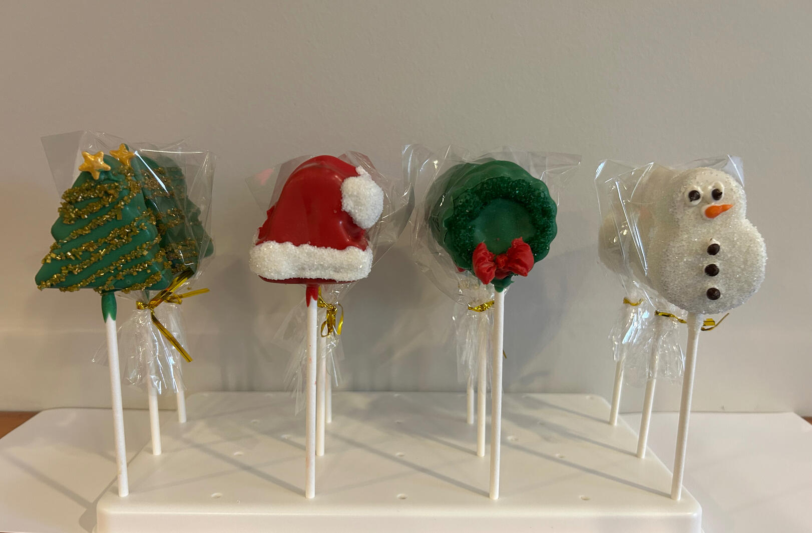 Cutie Pops Cake Pops available Holiday Shapes this year include Christmas Trees, Santa Hats, Christmas Wreaths, and Cute Little Snowmen
